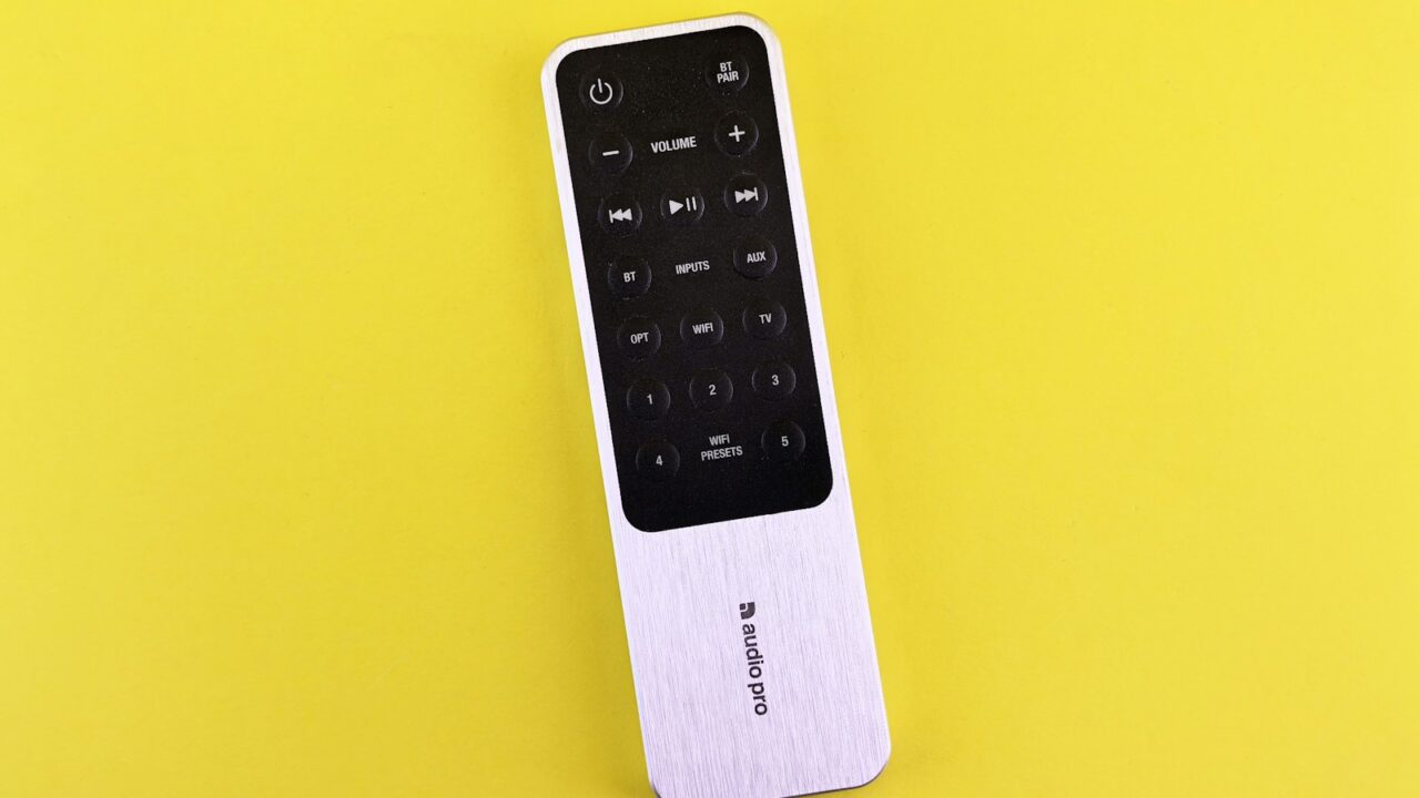 A remote control sitting on top of a yellow surface